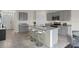 Modern kitchen with gray cabinets, granite counters, and an island at 2526 Sage Valley Way, Winter Haven, FL 33884