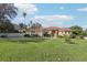 One-story home with red tile roof, landscaping, and driveway at 12616 Crown Point Cir, Clermont, FL 34711