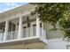 Two-story home's exterior with white balcony and railing at 1091 Indigo Dr # 201, Celebration, FL 34747