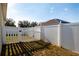 White vinyl fence encloses a grassy backyard area at 176 Blackstone Creek Rd, Groveland, FL 34736