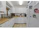Galley style kitchen, white cabinets, wood countertops, and refrigerator at 621 Oaklando Dr, Altamonte Springs, FL 32714