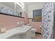 Clean bathroom with pink tile, a shower/tub combo, and updated vanity at 621 Oaklando Dr, Altamonte Springs, FL 32714