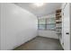 Empty storage room with tile floor, a window, and built-in shelving at 621 Oaklando Dr, Altamonte Springs, FL 32714