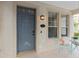 Inviting front porch with blue door and charming seating area at 226 W Tarrington Dr, Deland, FL 32724