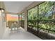 Relaxing screened porch with table and chairs, overlooks backyard at 226 W Tarrington Dr, Deland, FL 32724