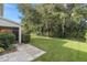 Large backyard with lush green grass and patio at 226 W Tarrington Dr, Deland, FL 32724