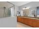 Bathroom with granite double vanity and shower at 226 W Tarrington Dr, Deland, FL 32724