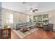 Spacious living room showcases hardwood floors, a comfortable sectional sofa, and large windows at 226 W Tarrington Dr, Deland, FL 32724