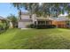 Spacious backyard with grassy area and screened porch at 226 W Tarrington Dr, Deland, FL 32724