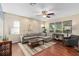 Living room with L-shaped sofa, hardwood floors, and ceiling fan at 226 W Tarrington Dr, Deland, FL 32724