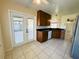 Kitchen with ample counter space, wood cabinets, and access to patio at 404 Fort Smith Blvd, Deltona, FL 32738