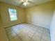 Well-lit bedroom featuring tile flooring at 404 Fort Smith Blvd, Deltona, FL 32738