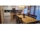 Kitchen with white cabinets, a breakfast bar, and a dining table at 115 Canna Dr, Davenport, FL 33897