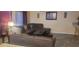 Living room with sectional sofa and grey tile floors at 115 Canna Dr, Davenport, FL 33897