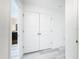 Hallway with white doors and light gray vinyl flooring at 947 Grandin St, Davenport, FL 33837