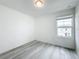 Simple bedroom with vinyl flooring and a window with natural light at 947 Grandin St, Davenport, FL 33837
