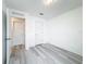 Bright bedroom with light gray vinyl flooring and double door closet at 947 Grandin St, Davenport, FL 33837