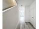 Bright hallway with stairs and light gray vinyl flooring at 947 Grandin St, Davenport, FL 33837