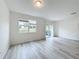 Bright and airy living room with vinyl plank flooring and sliding glass doors at 947 Grandin St, Davenport, FL 33837