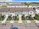 Aerial view of townhouses with attached garages and front yards at 947 Grandin St, Davenport, FL 33837