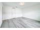 Simple bedroom with vinyl plank flooring and a door at 947 Grandin St, Davenport, FL 33837