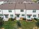 Aerial view of townhomes showcasing brown roofs, white exteriors, and private patios at 947 Grandin St, Davenport, FL 33837