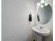 Simple, clean bathroom with pedestal sink and oval mirror at 947 Grandin St, Davenport, FL 33837