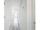 Long hallway with light gray vinyl flooring and doors to other rooms at 947 Grandin St, Davenport, FL 33837
