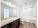 Clean bathroom with tub, shower, and dark brown vanity at 947 Grandin St, Davenport, FL 33837