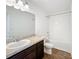 Clean bathroom with tub, shower, and dark brown vanity at 947 Grandin St, Davenport, FL 33837