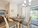 Bright dining area with a wooden table and sliding glass doors to patio at 653 Persian Dr, Haines City, FL 33844