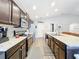 Modern kitchen with dark cabinetry, stainless steel appliances and granite countertops at 653 Persian Dr, Haines City, FL 33844