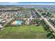 Aerial view of community with pool, playground, and soccer field at 653 Persian Dr, Haines City, FL 33844