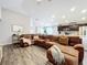 Spacious living room featuring a large sectional sofa and wood-look flooring at 653 Persian Dr, Haines City, FL 33844