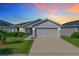 One-story home with gray siding, two car garage and landscaped yard at 653 Persian Dr, Haines City, FL 33844