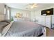 Spacious primary bedroom with large bed, dresser, and TV at 653 Persian Dr, Haines City, FL 33844