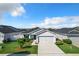 Aerial view of a house with a gray exterior and solar panels at 653 Persian Dr, Haines City, FL 33844