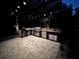 Outdoor kitchen with grill, sink, and pergola at 830 Oakdale St, Windermere, FL 34786