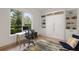 Home office with built-in shelving, murphy bed, and large window at 830 Oakdale St, Windermere, FL 34786