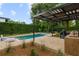 Modern outdoor kitchen and pool with pergola and seating at 830 Oakdale St, Windermere, FL 34786