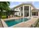 Luxury pool with pergola, outdoor kitchen, and lounge chairs at 830 Oakdale St, Windermere, FL 34786