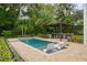 Inviting pool with pergola, outdoor kitchen, and lounge seating at 830 Oakdale St, Windermere, FL 34786