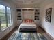 Guest bedroom with a murphy bed and built-in shelving at 830 Oakdale St, Windermere, FL 34786