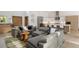 Open concept living room with a sectional sofa and modern kitchen at 830 Oakdale St, Windermere, FL 34786