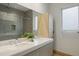 Double vanity bathroom with a large shower and modern fixtures at 830 Oakdale St, Windermere, FL 34786
