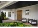 Inviting front porch with wooden doors and comfortable seating at 830 Oakdale St, Windermere, FL 34786