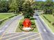 Entrance to the Highland Lakes community with a prominent sign and landscaping at 26721 Racquet Cir, Leesburg, FL 34748