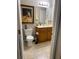 Clean bathroom with wood cabinets and tiled floor at 6312 Buford St # 304, Orlando, FL 32835