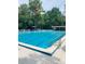 Inviting community pool with lounge chairs and umbrellas at 50 Sheoah Blvd # 34, Winter Springs, FL 32708