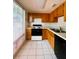 Galley kitchen with wood cabinets and modern appliances at 50 Sheoah Blvd # 34, Winter Springs, FL 32708